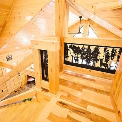 The loft at Deer Trail Cabin, with its deer-and-pine railing panels